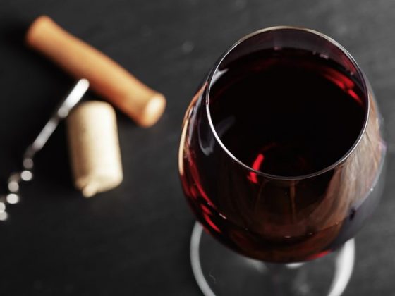 wine glass of red wine with a corkscrew. wine glass of red wine with a corkscrew.